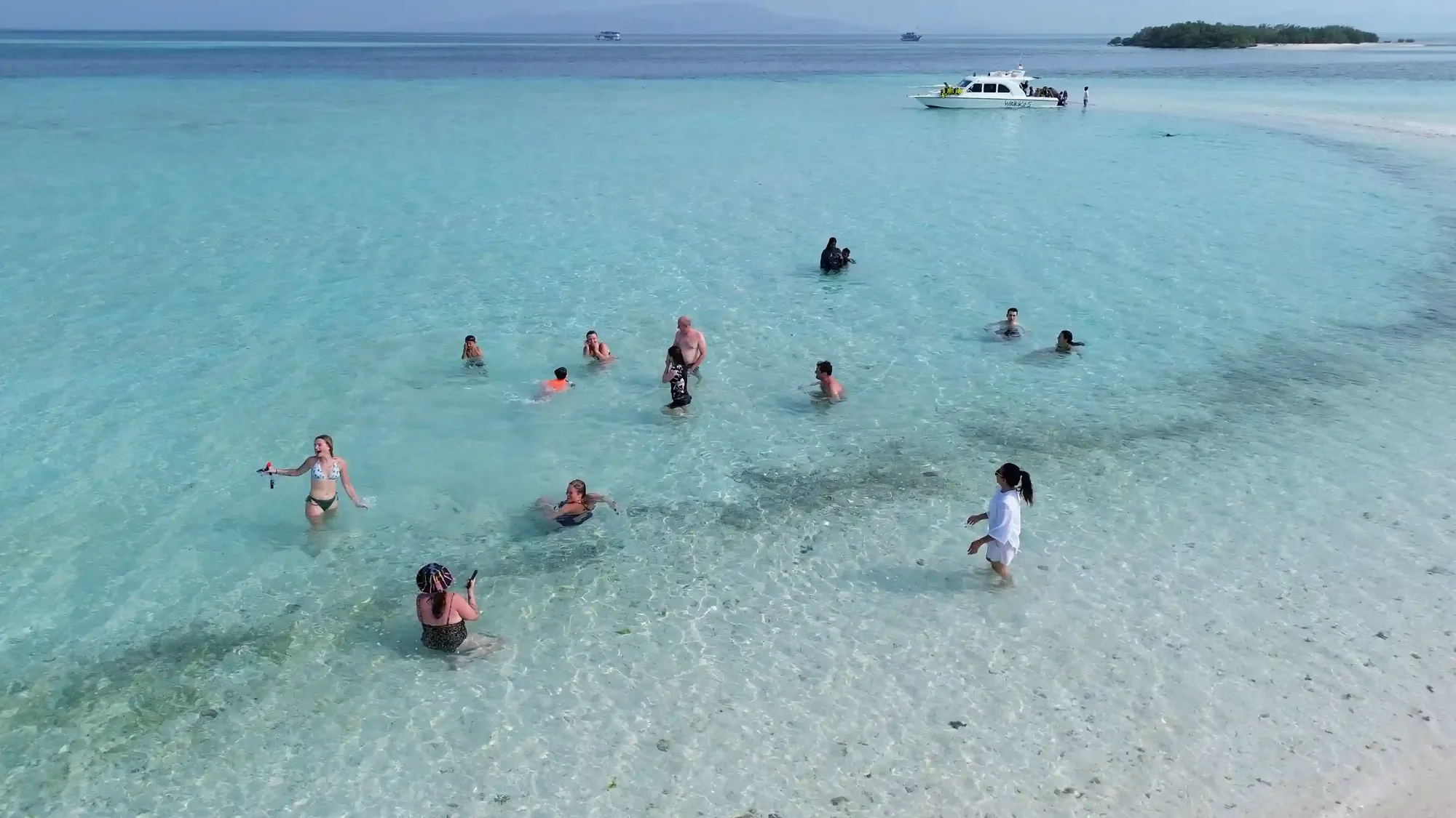 A curving sandbar in shallow turquoise water near Komodo